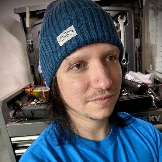 Blue beanie hat on model with Throttlenauts woven tag