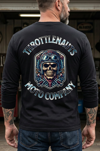Person wearing a black long-sleeve shirt with vintage fighter pilot skull and throttlenauts logo in a garage setting