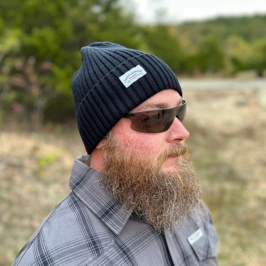 Black beanie hat on model with Throttlenauts woven tag